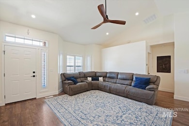 Living area featuring dark wood-type flooring, a ceiling fan, recessed lighting, and lofted ceiling