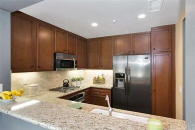 Open kitchen with granite counters, travertine bac