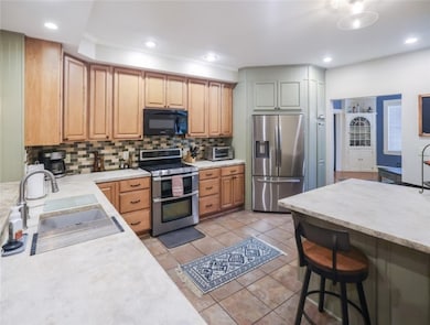 This kitchen is perfectly positioned between the living & family room.  With it's open floor plan, it keeps all 3 rooms connected.
