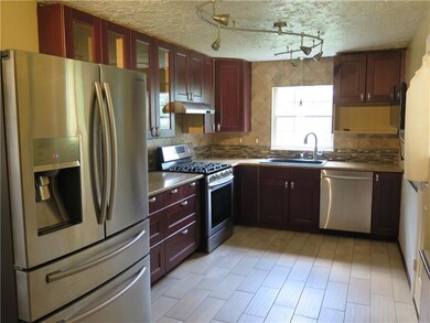 Kitchen 9x21 completely updated with new appliances, cabinetry with mosaic tile back splash and porcelain tile floor