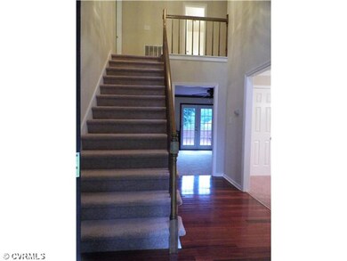 Foyer - Extra wide stairs make the room appear gra