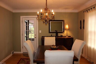 Dining room with coved ceiling and hardwood floors