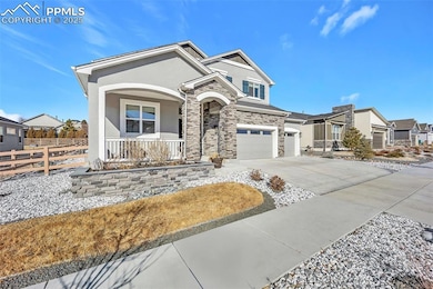 View of front of home with a garage and covered po