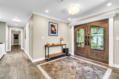 Entryway featuring french doors, crown molding, re