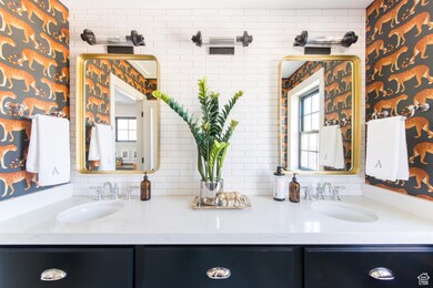 Bathroom featuring tasteful backsplash and vanity