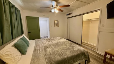 Bedroom with wood finished floors and ceiling fan