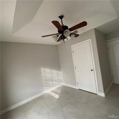 Unfurnished bedroom featuring ceiling fan and light tile flooring