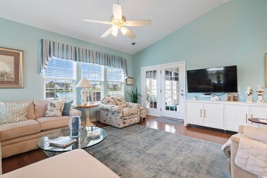 Living room featuring lofted ceiling, dark hardwoo