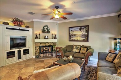 Family room with crown molding, ceiling fan, firep