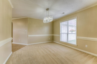 Unfurnished room with carpet, plenty of natural li