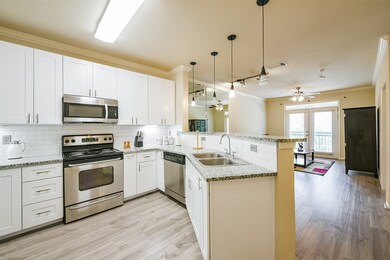 Modern kitchen with white cabinetry, stainless ste