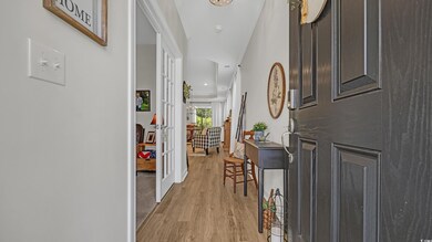 Foyer entrance with light wood-style floors and french doors