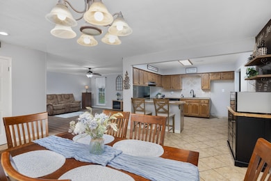Open the front door into a homey dining and kitchen area.