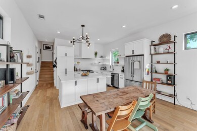 Kitchen with open shelves, light countertops, a s