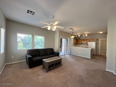 Living area featuring light carpet, baseboards, an