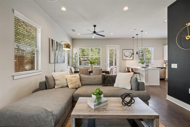 Living room with visible vents, a ceiling fan, da