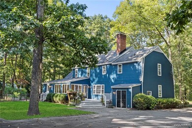 Colonial house featuring a front lawn