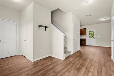 Foyer featuring light wood-type flooring, stairs, 