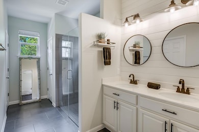 Ensuite bathroom with double vanity, a shower sta
