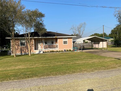 VIEW OF HOME WITH DETACHED CARPORT.  SMALL STORAGE ON PROPERTY.