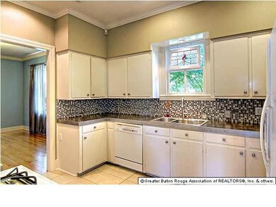 Modern kitchen with concrete countertops and glass