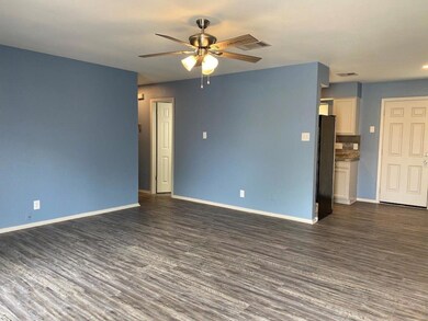 Unfurnished living room featuring wood finished f