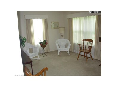 Carpeted living room with large picture window.