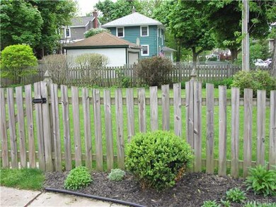 Yard. Fully fenced side yard surrounded by gardens