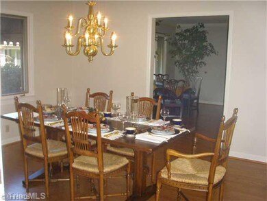 Dining Room. Wonderful for entertaining your family.  Overlooks the beautiful landscaping and pool.