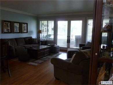 Living room with wood floors, custom window coveri