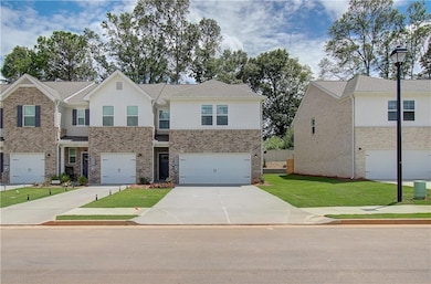 View of front of home with a front lawn and a gara