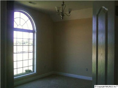 Double doors with arched detail & lovely palladium window set the stage for a stylish study!