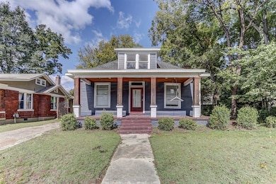 Bungalow-style house with a porch and a front yard