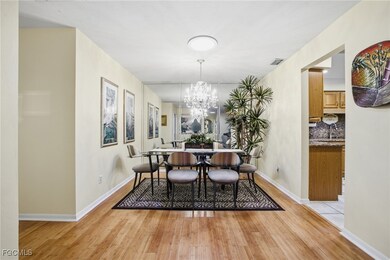 Dining room with light wood-style flooring and a chandelier