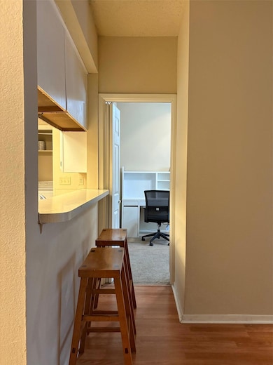 Hallway featuring wood finished floors, baseboard