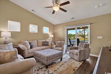 Living room featuring ceiling fan, wood finished floors, vaulted ceiling, and baseboards