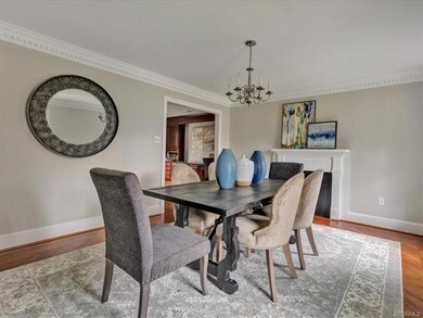 Formal dining room with dental molding and hardwoo