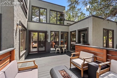 Wooden terrace featuring an outdoor fire pit