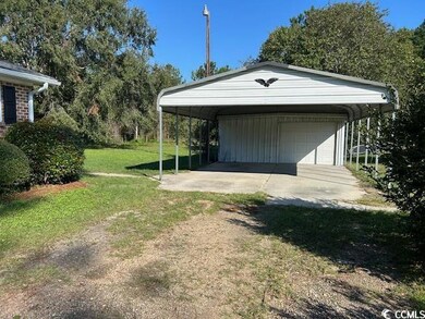 Garage with a yard and a carport
