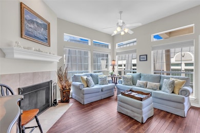 Living room featuring a ceiling fan, wood-type fl