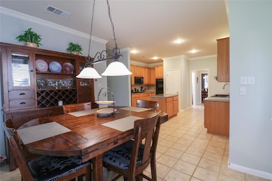 Dining space featuring crown molding, light tile 