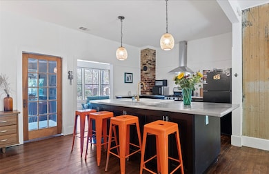 Kitchen with light countertops, dark wood-type fl