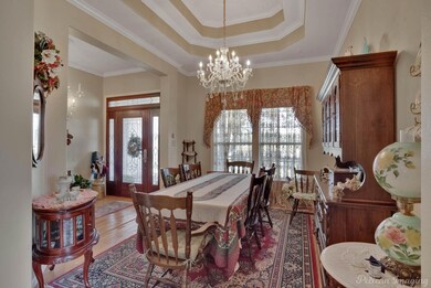 Dining space with ornamental molding, a chandelier
