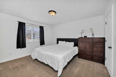 Carpeted bedroom featuring baseboards
