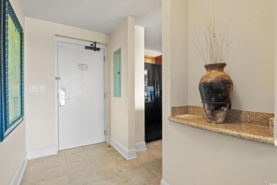 Entryway featuring baseboards, light tile patterned floors, and electric panel