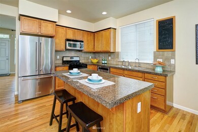 Spacious granite Kitchen with hardwoods and generous center island with eating bar.