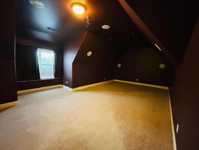 Bonus room with carpet floors, lofted ceiling, and baseboards