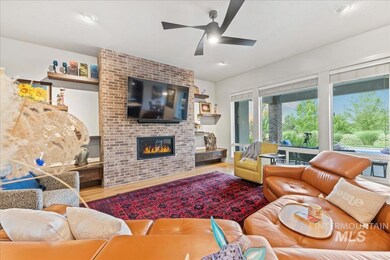 Living area with wood finished floors, plenty of natural light, ceiling fan, and recessed lighting