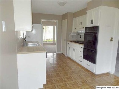 view of double oven and goose neck faucet in kitch