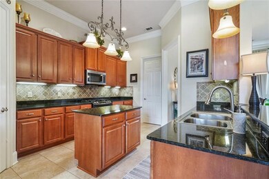 Kitchen island, ss appliances and stone countertop